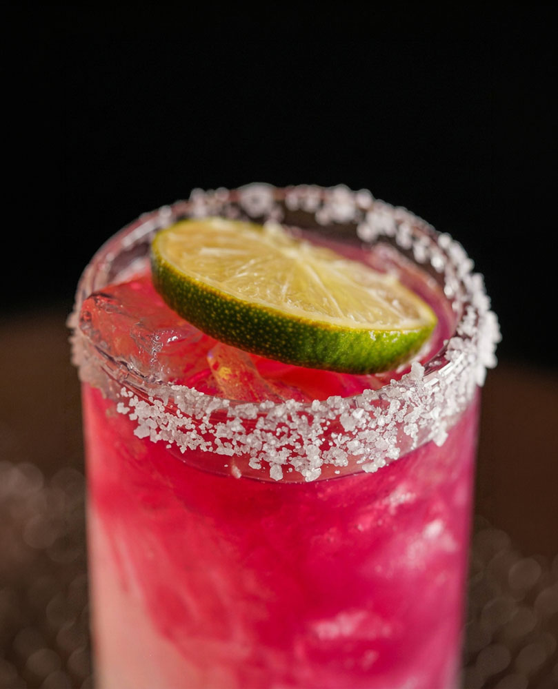 Sangria with a salt rim, ice, and fresh lime garnish.